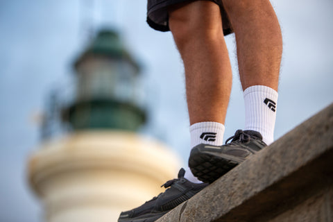Person wearing white exersox grip socks, while they are our on a walk